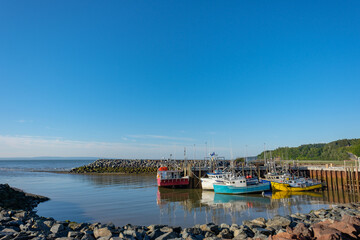 Low tide at a Canadian harbor grounds the fishing fleet on the Bay of Fundy