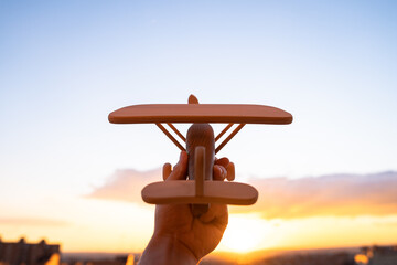 wooden airplane in the sunset sky ecological concept toy