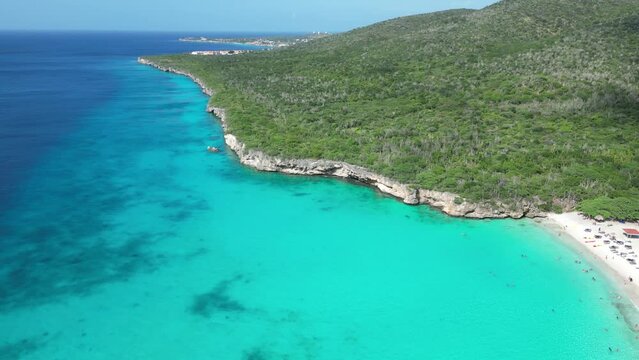 Aerial drone footage over Grote Knip in West Punt Curaca. Carribean beach drop down footage over the clear sea and sand