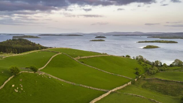 Aerial view of Cong Village surrounded by agricultural fields along Lough Corrib lake, Ireland.