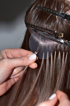 Hot hair extensions on micro capsules. Italian hair extension technology. Hair extensions for keratin.