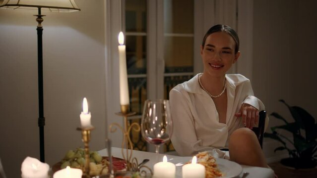 Smiling lady flirting at romantic dinner place close up. Woman coquet at evening