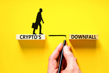 Crypto downfall symbol. Concept words Cryptos downfall on wooden blocks. Beautiful yellow table yellow background. Businessman hand. Business and crypto downfall concept. Copy space.