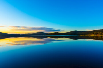 Fototapeta premium Peaceful landscape of Lake Inari with the midnight sun in Lapland, Finland