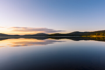 Peaceful landscape of Lake Inari with the midnight sun in Lapland, Finland - obrazy, fototapety, plakaty