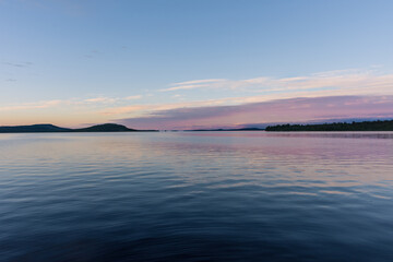 Peaceful landscape of Lake Inari with the midnight sun in Lapland, Finland