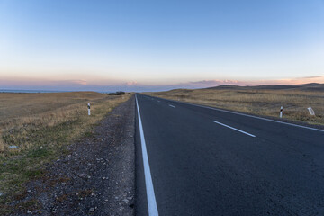 Asphalt road going through the fields