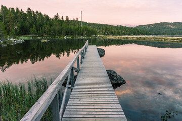 Peaceful landscape of Lake Inari with the midnight sun in Lapland, Finland