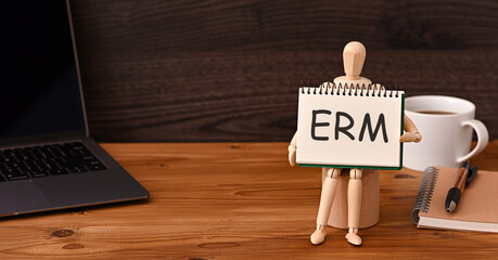 There is sketchbook with the word ERM. It is an abbreviation for Enterprise Risk Management as eye-catching image.