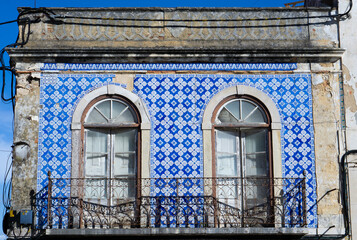 Azulejos in Portugal, detail on a typical house, blue color. Portugese balcony.