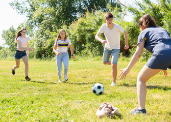 Obraz premium Teenagers play street football with excitement in city park