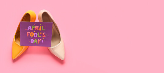 Shoes and card with text APRIL FOOL'S DAY on pink background with space for text