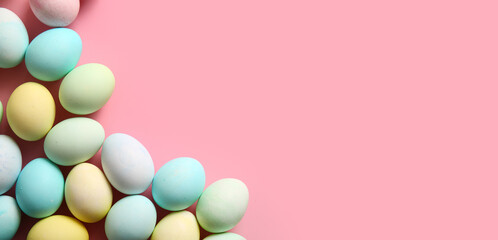 Many beautiful Easter eggs on pink background with space for text
