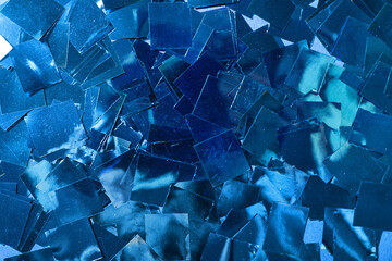 Blue confetti as background, closeup