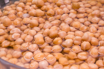 Top view on a group of soaked chickpeas on water