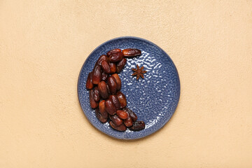 Plate, crescent with star made of dates and anise for Ramadan on beige background