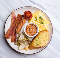 English Breakfast Style ham sausage omelet white peanut and bread on  white marble Table 