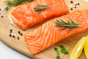 Fresh salmon and ingredients for marinade on wooden board, closeup