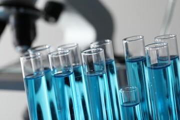 Test tubes with light blue liquid in laboratory, closeup