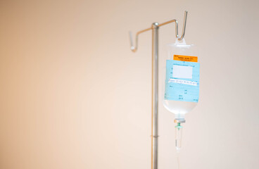 The saline bag hanging on the IV pole in the emergency room at the hospital.