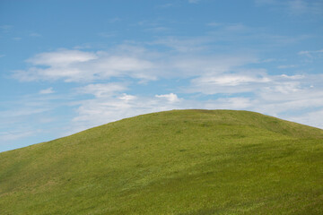 Empty green hill and blue sky Easter background