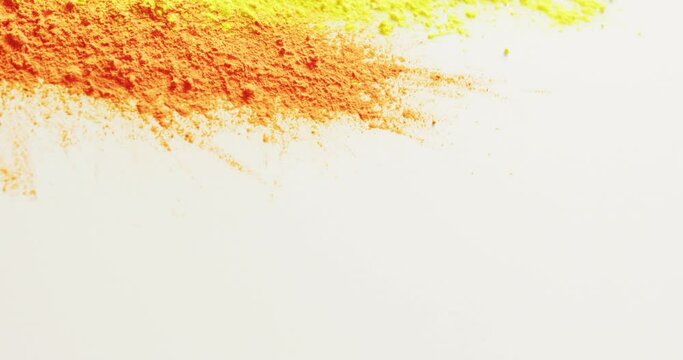 Video of multi coloured powders with copy space on white background