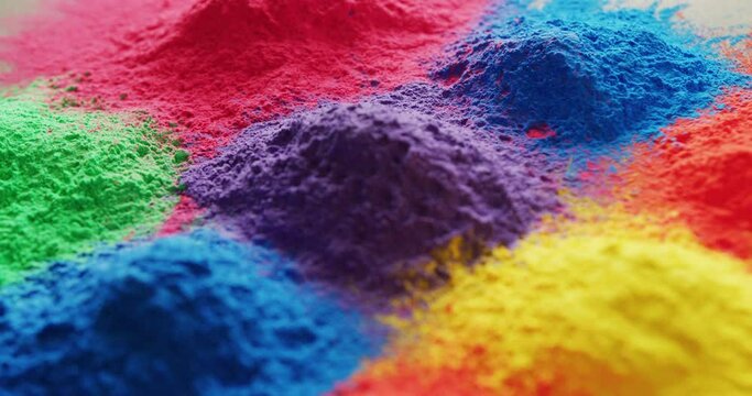Video of close up of multi coloured powders with copy space on white background