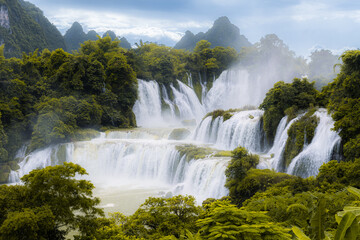 Fototapeta premium Ban Gioc Waterfall on the Quy Xuan River is located in Cao Bang Province, nears the Sino-Vietnamese border. The waterfall falls thirty meters. Located in Northern of Vietnam