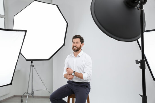 Handsome model posing in modern studio. Professional photo session