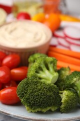 Plate with delicious hummus and fresh vegetables, closeup
