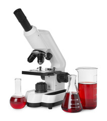 Laboratory glassware with red liquid and microscope isolated on white