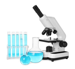 Laboratory glassware with light blue liquid and microscope isolated on white