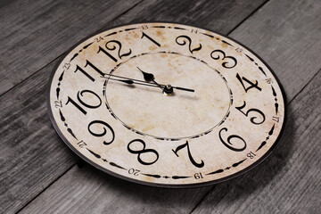 Clock showing five minutes until midnight on wooden table. New Year countdown
