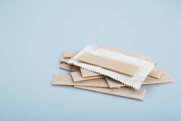Many sticks of tasty chewing gum on light grey background. Space for text