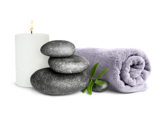 Beautiful composition with burning candle, stacked stones and rolled towel on white background. Spa therapy