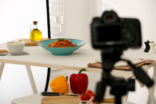 Professional camera and composition with spaghetti in photo studio, space for text. Food photography