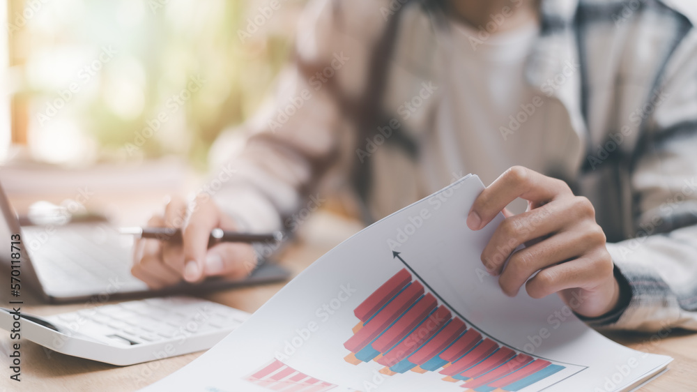 Poster businessman calculating figures in company financial documents with a calculator, analysis of compan