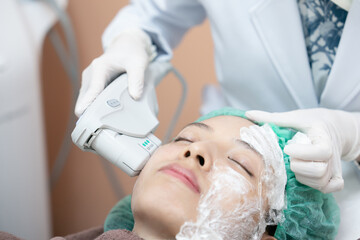 Beautician procedure by electric device,Ultrasound therapy treatment for skin tightening in aesthetic clinic.