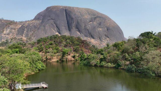 Static wide shot of Aso Rock with a lake in Abuja, Nigeria