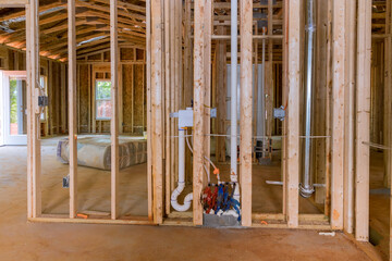 Fototapeta na wymiar Newly built house should have all communication lines and plumbing installed prior to plasterboard, which is part of framing beams wood stick building.