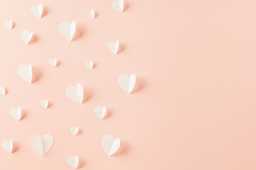 Top view flat lay of paper elements cutting white hearts shape flying on pink background, Banner template greeting card design of holiday, Love and Valentines Day background