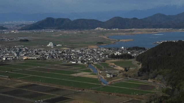 西の湖と安土城址を背景に走る223系新快速列車
