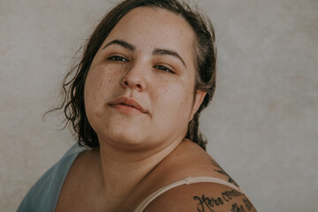 close-up plus size metis woman face with freckles and pimples