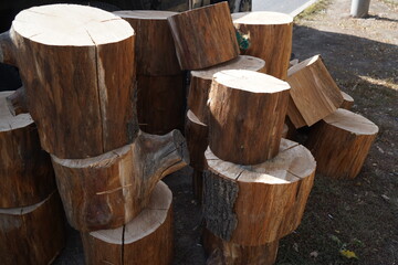 Small pieces of sawn wood are stacked on top of each other in a city park.