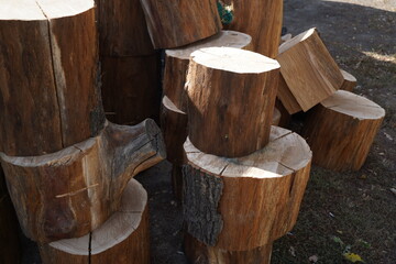 Small pieces of sawn wood are stacked on top of each other in a city park.