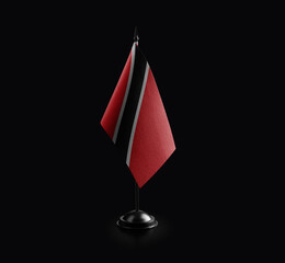 Small national flag of the Trinidad and Tobago on a black background