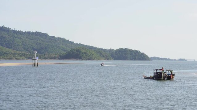 View of speed boat over waters near mangrove forest, Thailand