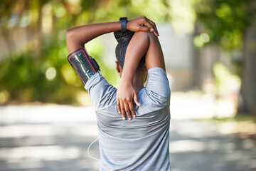 Black woman, fitness and stretching arms for running, cardio exercise or workout preparation in nature. African American female in warm up arm stretch behind back getting ready for run or training