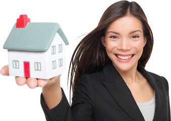 Real estate agent selling home holding mini house. Female realtor in business suit smiling happy...