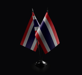 Small national flags of the Thailand on a black background